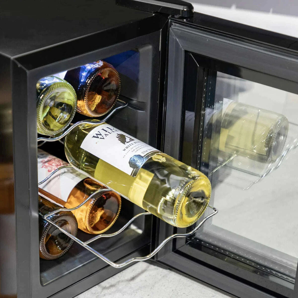 Sleek Baridi 6-bottle wine cooler with glass door, touch controls, and digital display.