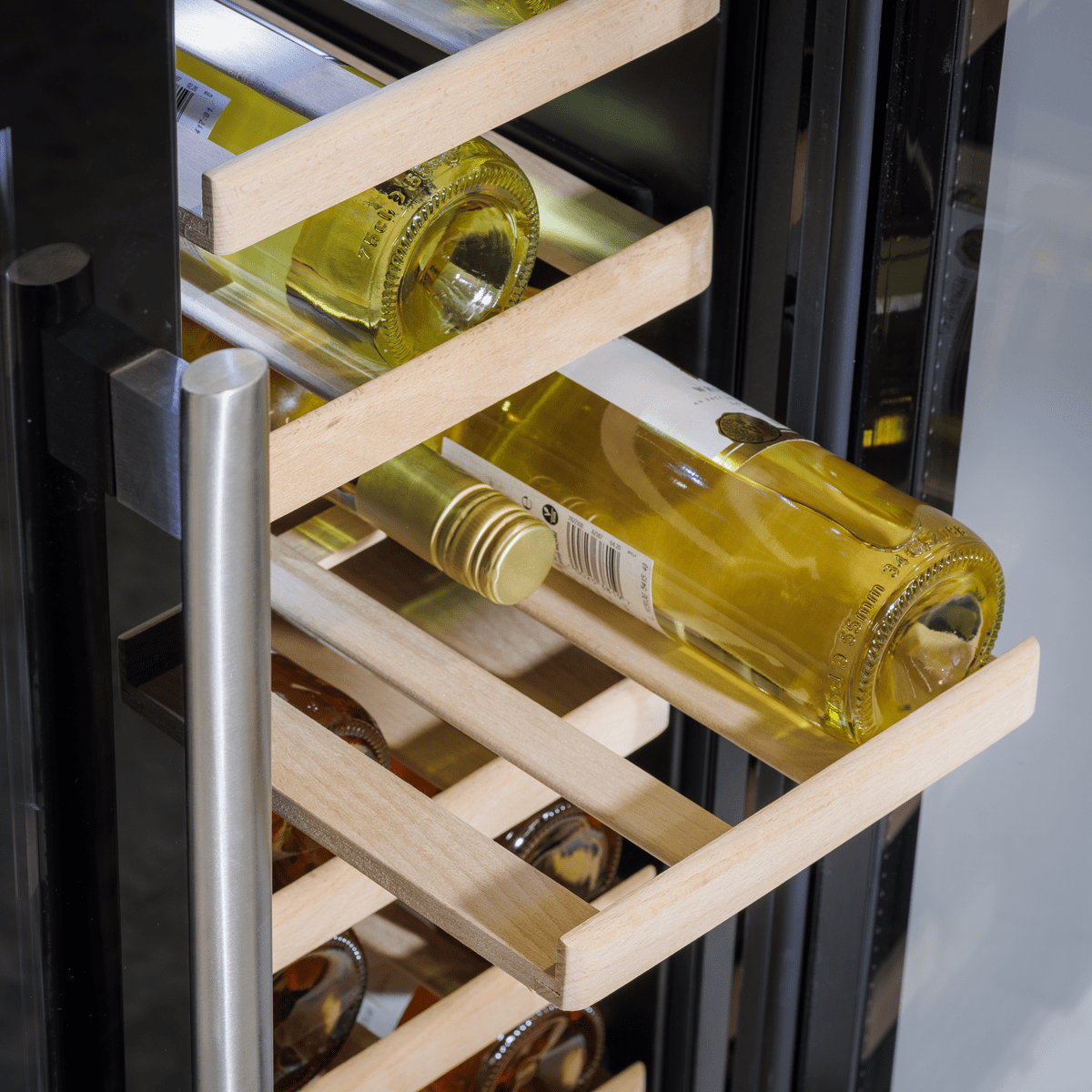 Baridi dual zone wine cooler with glass doors, displaying wine bottles and cans on wooden shelves.
